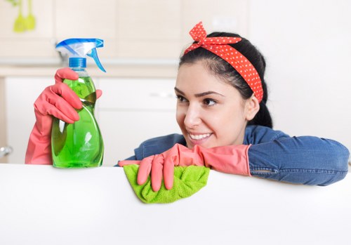 Cleaner using protective gloves and footwear during carpet cleaning